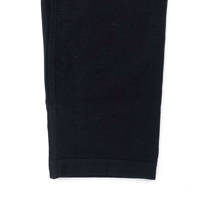 Vue latérale détaillée de la manchette noire Opex couvrant tatouages, mettant en avant coupe anatomi