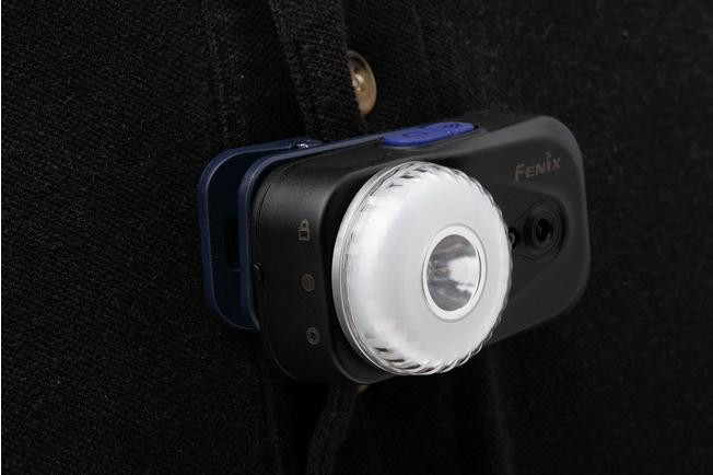 Person wearing 1418403 Fenix HL17R headlamp outdoors at night, illuminating path.